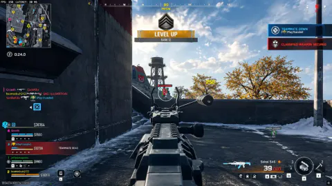 Rooftop Warzone firefight in light snow, iron sights on a highlighted enemy with squad HUD and level-up banner visible.